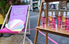 Premium high-street product display stand showcasing So Fragrance body mists and scents at an outdoor experiential roadshow