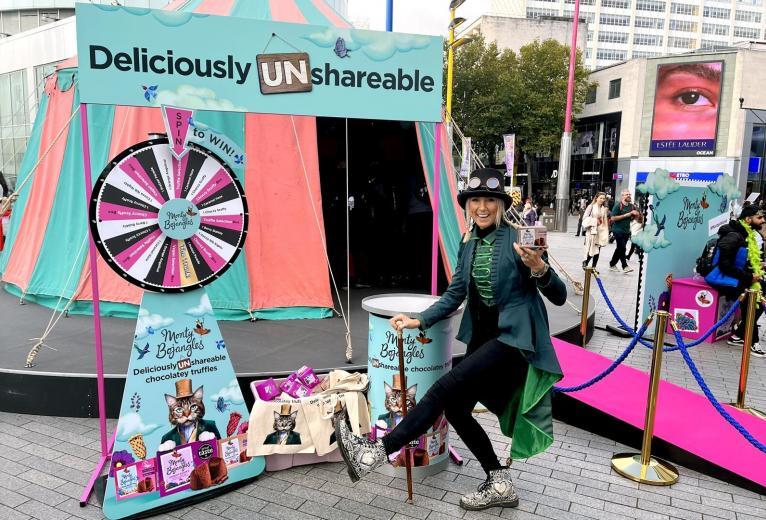 Brand ambassador posing in front of the Monty Bojangles sampling tent.