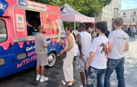 People queuing at the Tide Banking branded ice cream van