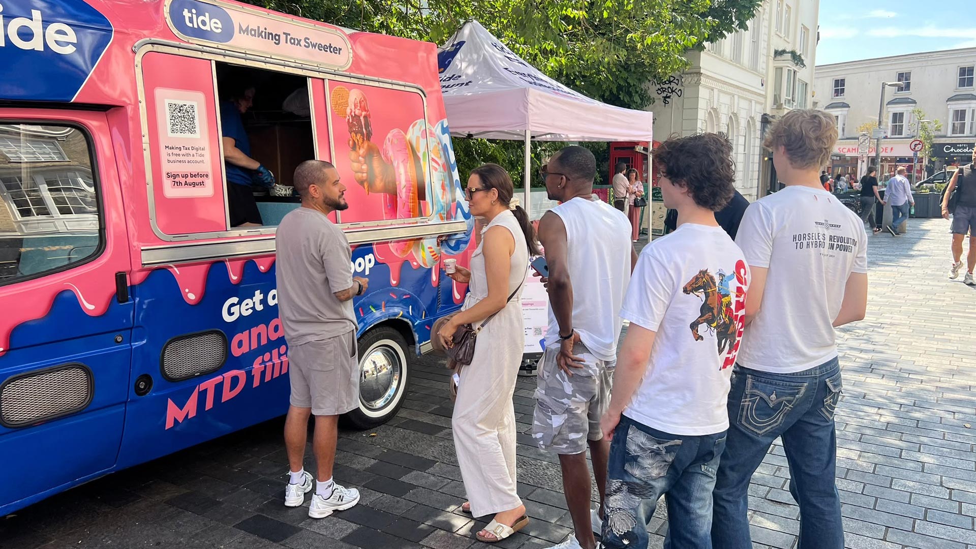 People queuing at the Tide Banking branded ice cream van