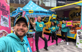 Energetic iMP brand ambassadors interacting face-to-face with consumers during a live street sampling campaign