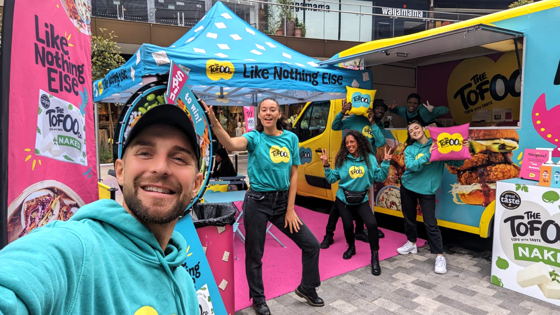 Energetic iMP brand ambassadors interacting face-to-face with consumers during a live street sampling campaign